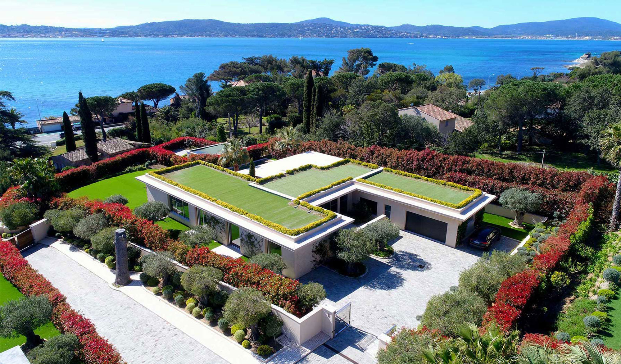 Modern villa with rooftop garden by the sea.